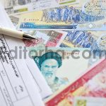 Iranian annual income tax return form F20-25-006 ready to fill on table with iranian money