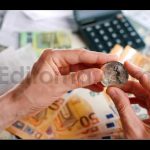 Hands Shows BTC Bitcoin Against the Dollars and Euros